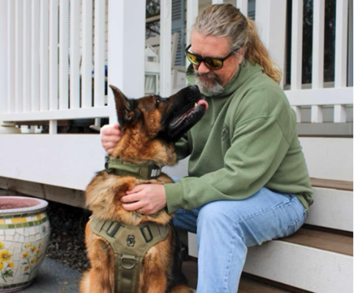 Man on porch with service dog